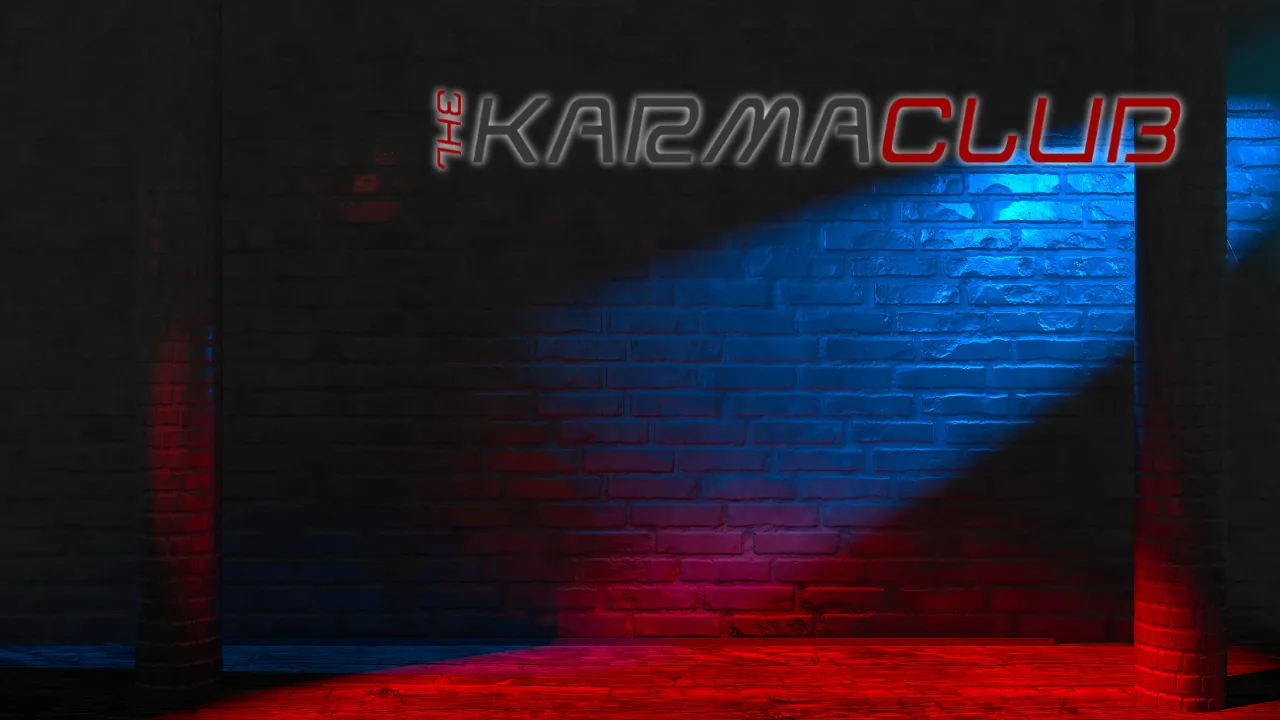 Empty stage with blue and red lighting against a brick wall featuring The Karma Club logo